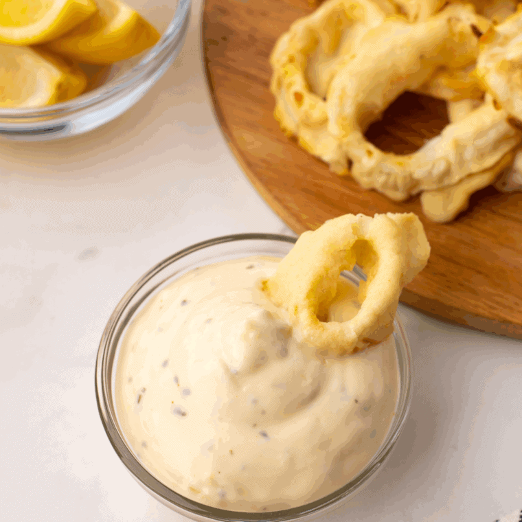 Homemade Ina Garten tartar sauce served in a bowl with lemon and dill garnish.