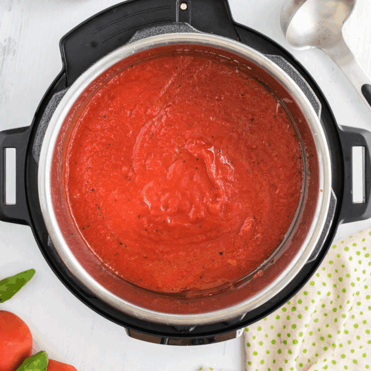 Instant Pot sealed and set to High Pressure, cooking tomato basil soup ingredients together.