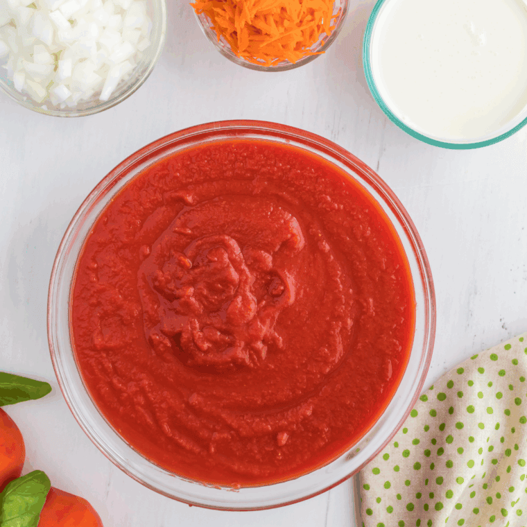 Ingredients needed for Instant Pot Madeleine Tomato Basil Soup on kitchen table.