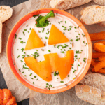 Serve up spooky fun with this Jack-O'-Lantern Onion Dip! Creamy, savory, and perfect for Halloween parties, it’s a festive dip everyone will love.