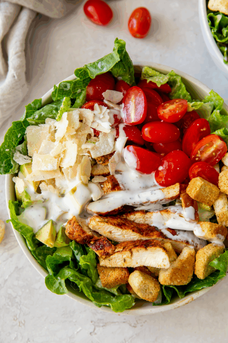 Copycat Longhorn Steakhouse Grilled Caesar Salad with charred romaine, creamy Caesar dressing, Parmesan cheese, and crunchy croutons.