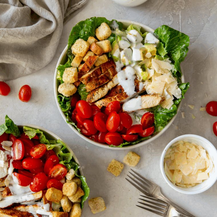Copycat Longhorn Steakhouse Grilled Caesar Salad with charred romaine, creamy Caesar dressing, Parmesan cheese, and crunchy croutons.