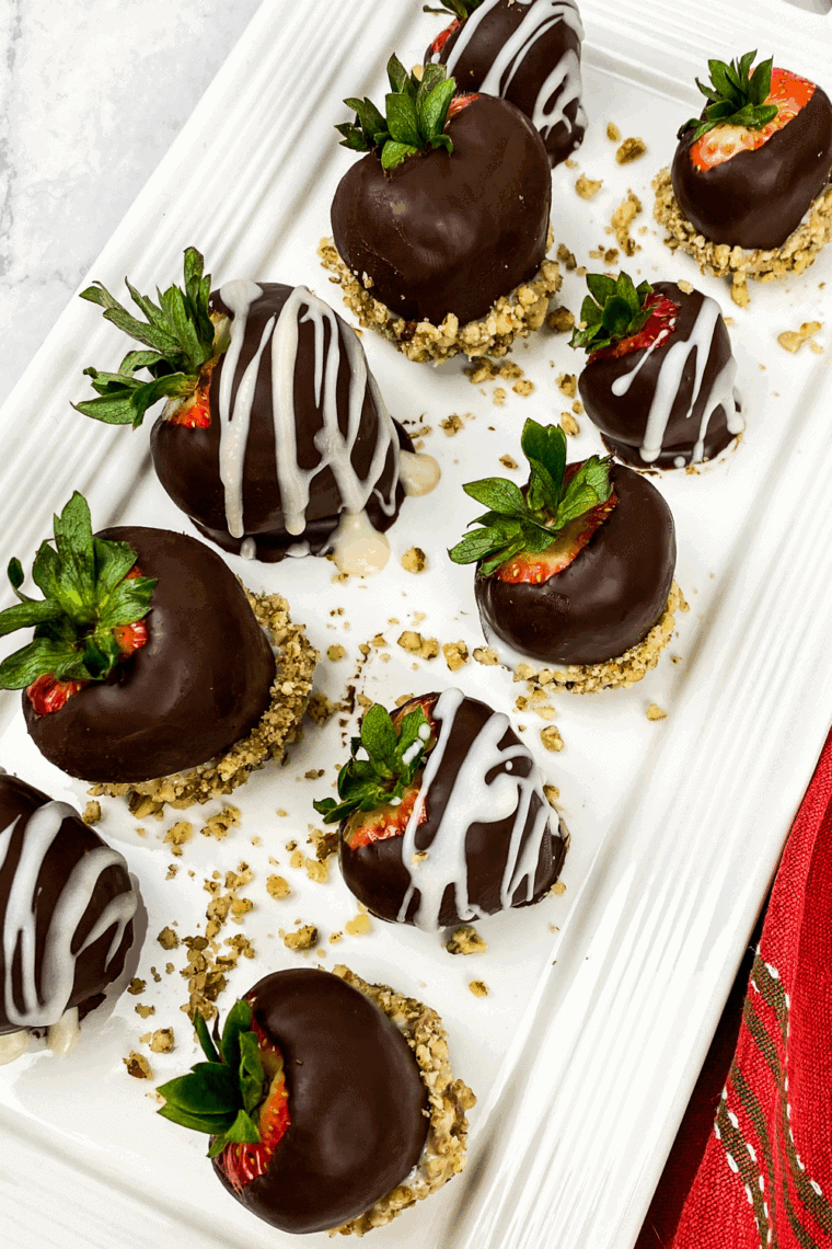 Fresh strawberries are dipped in dark chocolate for homemade snacks.