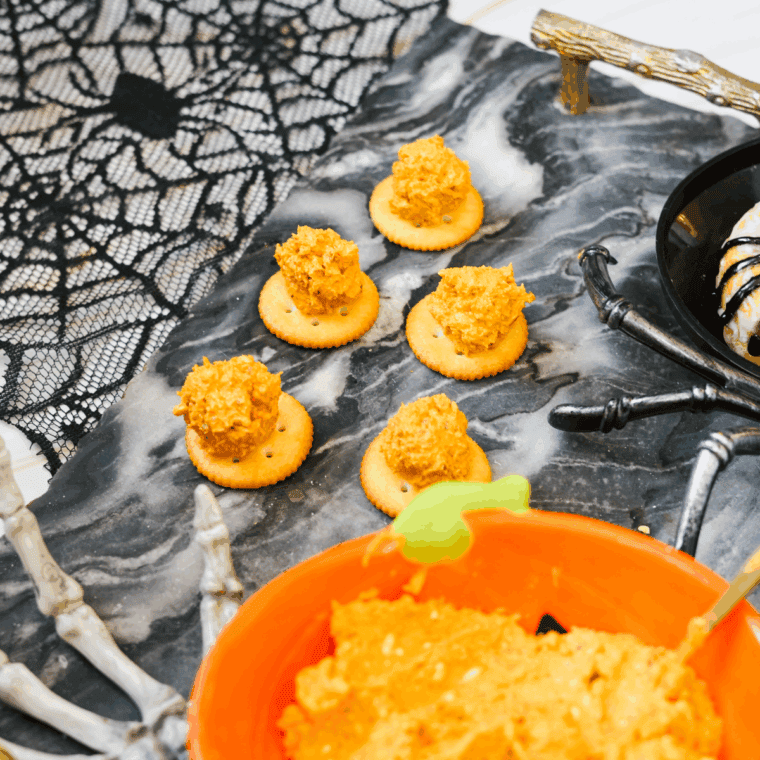 Pretzel sticks insert cheese balls as pumpkin stems