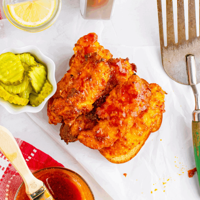 Place Cheesecake Factory Nashville Hot Chicken Nuggets on toast and serve with chips and pickles.