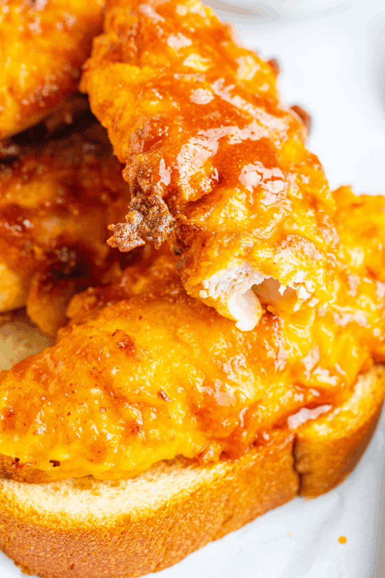 Close up of Nashville Hot Chicken Nuggets (Cheesecake Factory Copycat Recipe) on white plate.