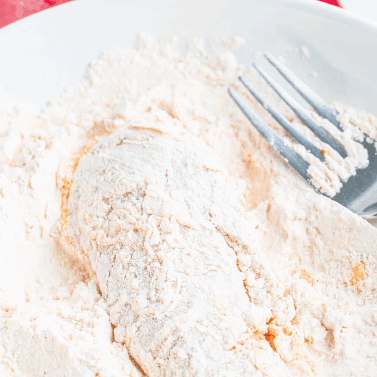 Steps for achieving Nashville Hot Chicken Nuggets – marinating chicken in buttermilk and hot sauce, dredging in seasoned flour, frying until crispy, coating with spicy Nashville hot sauce and serving over pickles and dipping sauces.