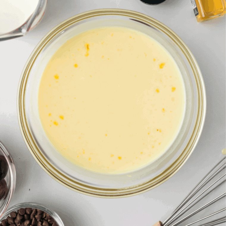Mixing heavy cream, whole milk, sugar, and vanilla in a bowl until smooth.