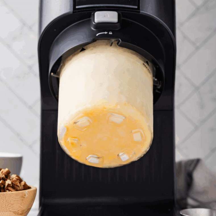 Placing the frozen pint in the Ninja Creami machine on the Ice Cream setting for smooth, creamy texture.