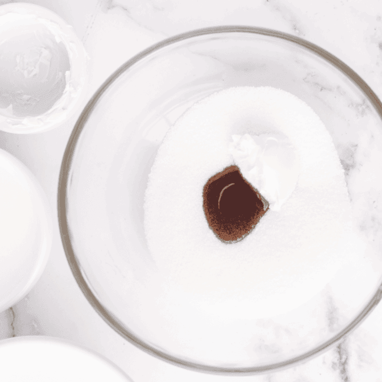 Whisking milk, heavy cream, sugar, and vanilla in a bowl to make ice cream base.