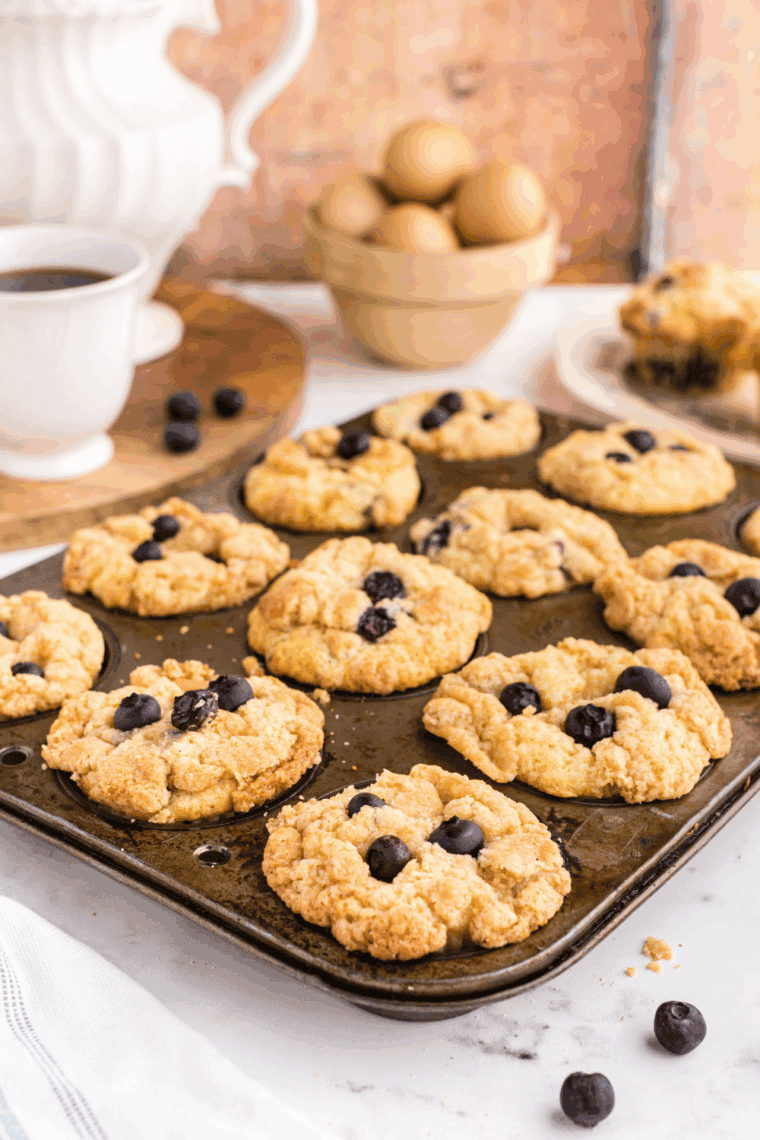 Freshly baked blueberry muffins cooling on a rack