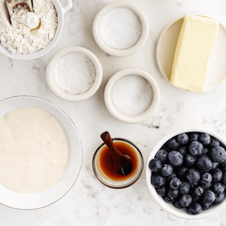 Ingredients needed for Tim Hortons Blueberry Muffins on kitchen table.