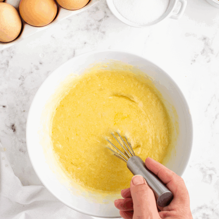 Wet ingredients in a bowl—milk, melted butter, egg, and vanilla whisked smooth.