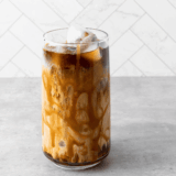 Homemade Tim Hortons iced coffee served over ice in a glass.