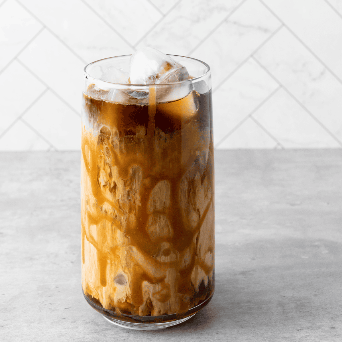 Homemade Tim Hortons iced coffee served over ice in a glass.