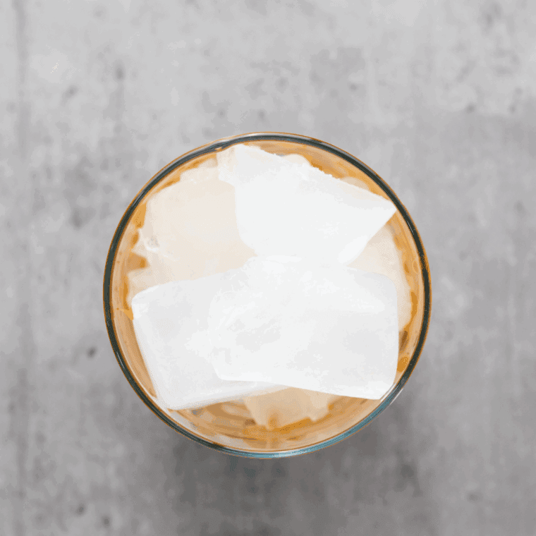 Glass filled with ice, chilled coffee, and milk poured in.