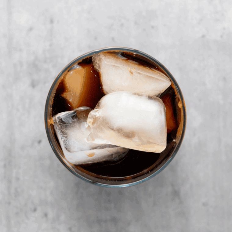 Glass filled with ice, chilled coffee, and milk poured in.