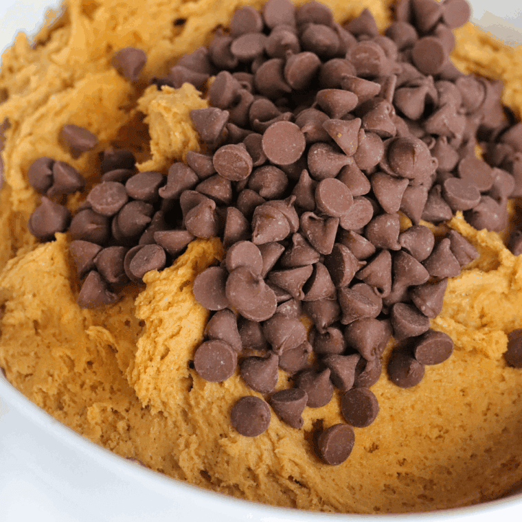 Adding flour, baking soda, and salt to peanut butter cookie dough.