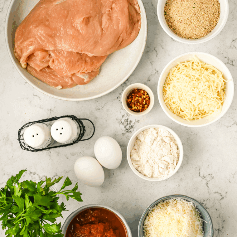 Ingredients needed for Barefoot Contessa Chicken Parmesan on kitchen table.