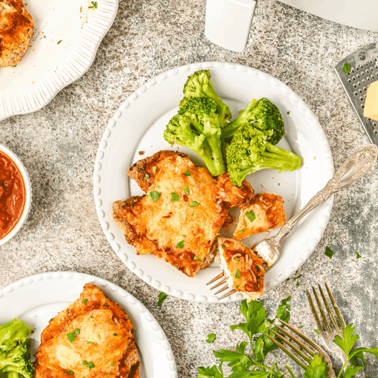 Crispy Barefoot Contessa Chicken Parmesan with marinara sauce and melted mozzarella, served hot and golden brown.