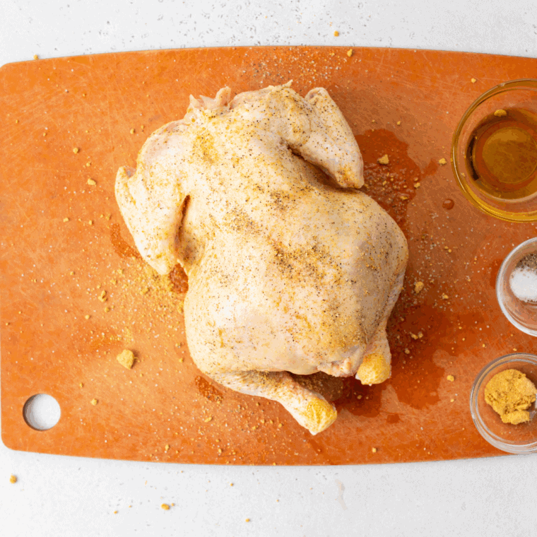 Coating Cornish hens evenly with the marinade before resting.
