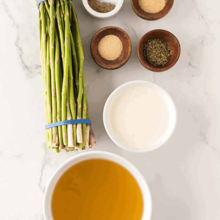 Ingredients needed for Barefoot Contessa's Cream of Asparagus Soup on kitchen table.