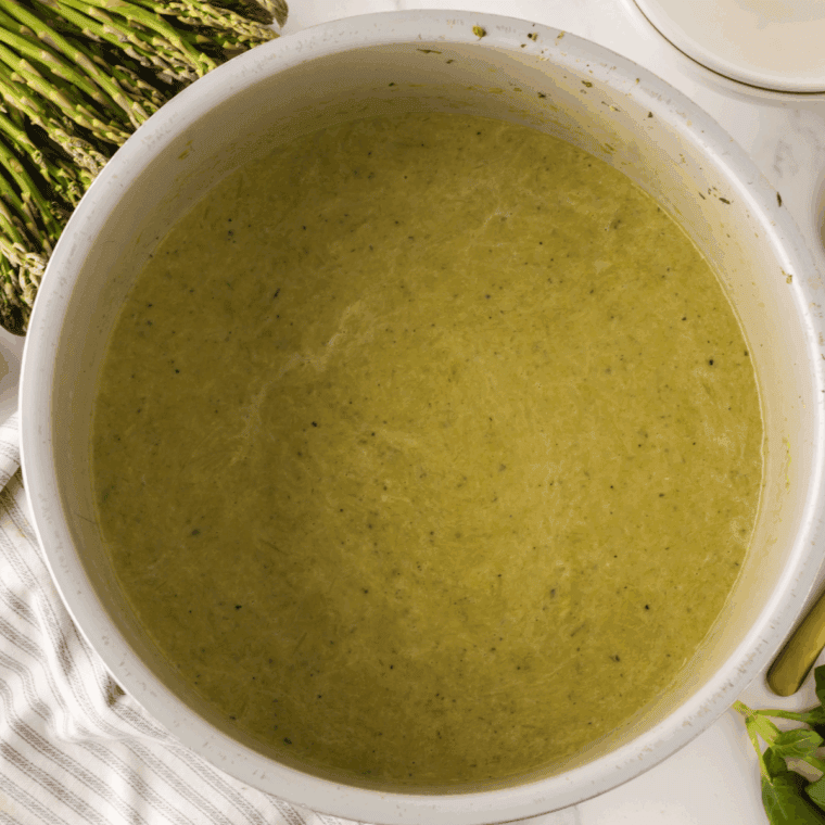 Bowl of Barefoot Contessa’s Cream of Asparagus Soup, garnished with fresh herbs and served warm.