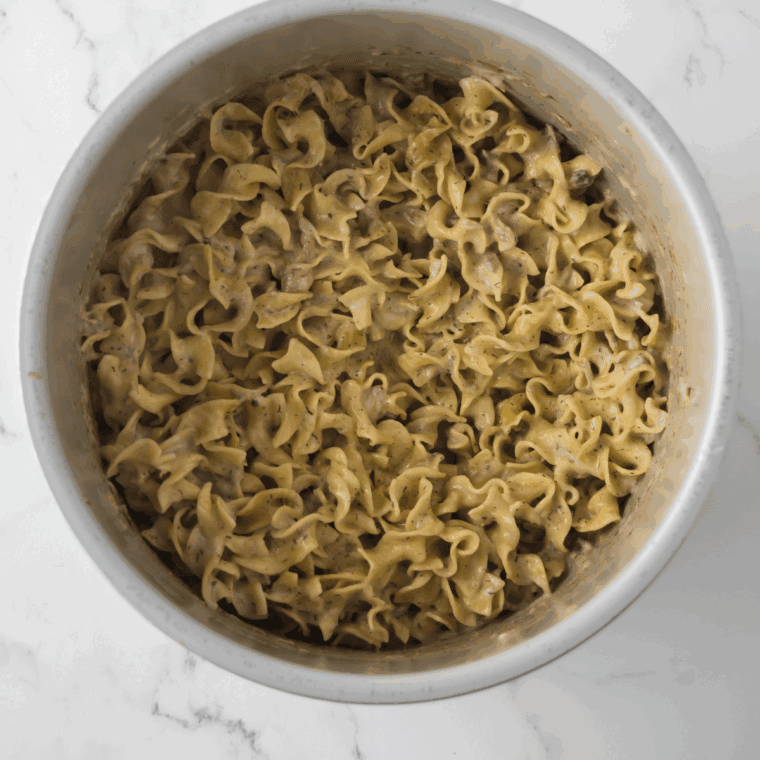 Mixing cream of mushroom soup, mayonnaise, and milk in a bowl for casserole sauce.
