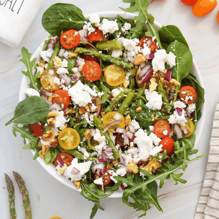 Citrus herb vinaigrette poured over a fresh salad, ready to serve, or stored in a glass jar in the fridge.