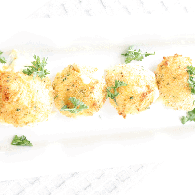 Golden, crispy jalapeño cheese bites on a plate, ready to serve.