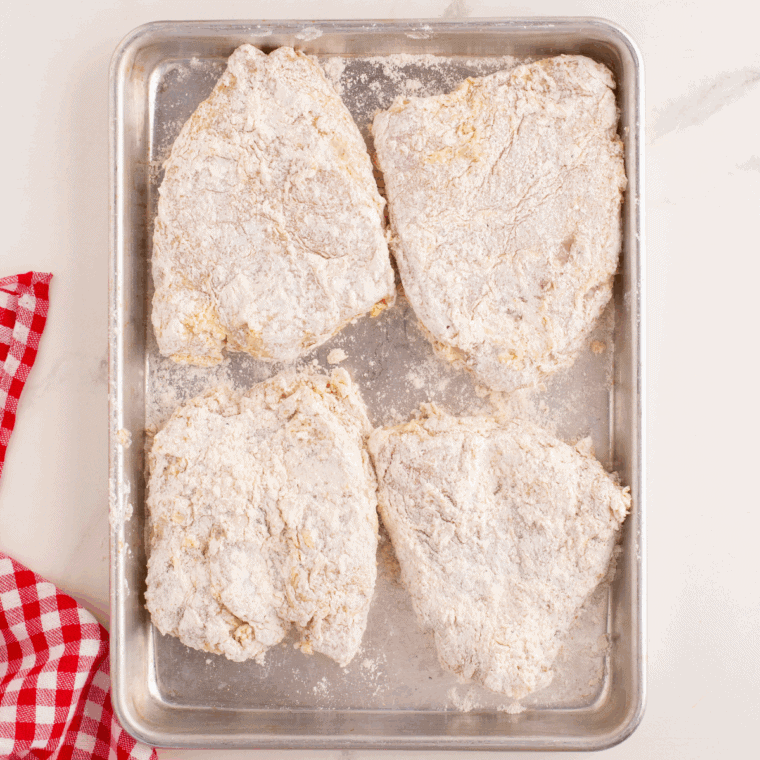 Dip each marinated chicken breast into beaten eggs, then coat generously with the flour mixture.