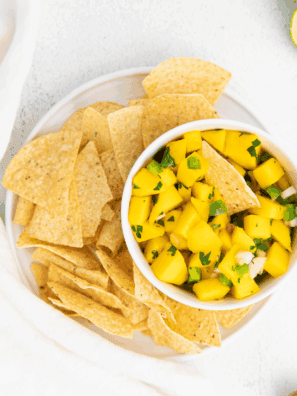 Bowl of vibrant mango salsa with diced mango, red bell pepper, jalapeño, and fresh herbs.