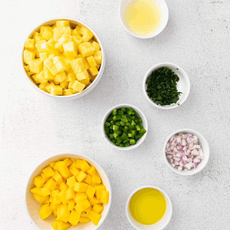 Ingredients needed for Copycat Bonefish Grill's Mango Salsa on kitchen table.