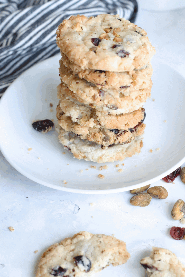 Freshly baked Copycat Crumbl Cranberry White Chip Cookies on a cooling rack, showing chewy texture and melted white chocolate chips.