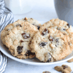 Freshly baked copycat Crumbl cranberry white chip cookies on a cooling rack, soft and chewy with visible cranberries and white chocolate chips.