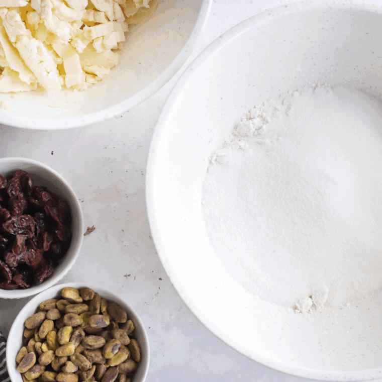 Ingredients needed for Copycat Crumbl Cranberry White Chip Cookie Recipe on kitchen table.