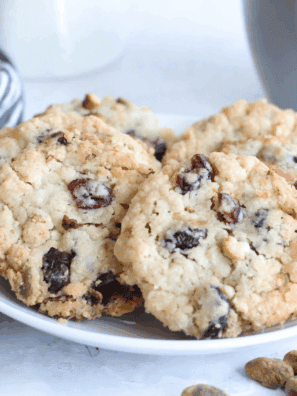 Freshly baked copycat Crumbl cranberry white chip cookies on a cooling rack, soft and chewy with visible cranberries and white chocolate chips.
