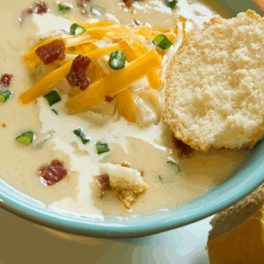 Bowl of creamy Copycat La Madeleine Country Potato Soup garnished with herbs.