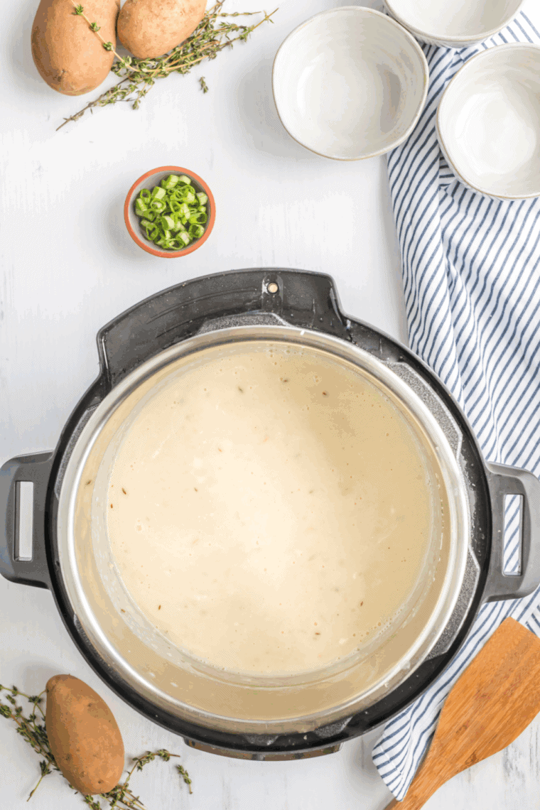 Bowl of creamy Copycat La Madeleine Country Potato Soup garnished with fresh parsley.