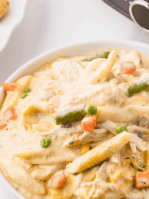Creamy Crock Pot Chicken Pot Pie Pasta with chicken, peas, carrots, and noodles in a rich sauce.