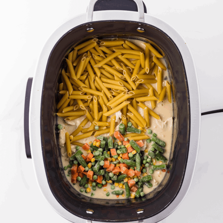 Place frozen vegetables and pasta into the slow cooker.