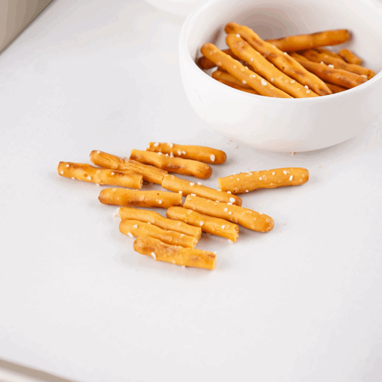 Snapping pretzel sticks in half to use as acorn stems.