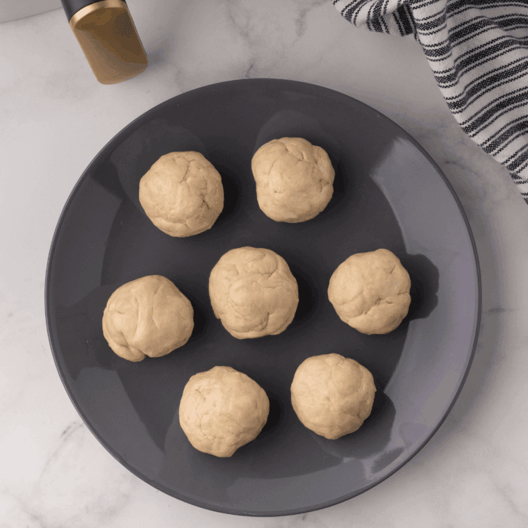 Divide the dough into balls and use a rolling pin to roll each ball into a thin, round tortilla.