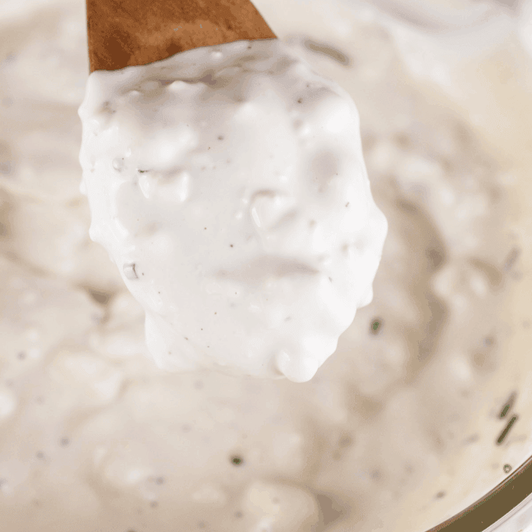 Medium bowl of mayonnaise, sour cream, and buttermilk whisked smooth and creamy.