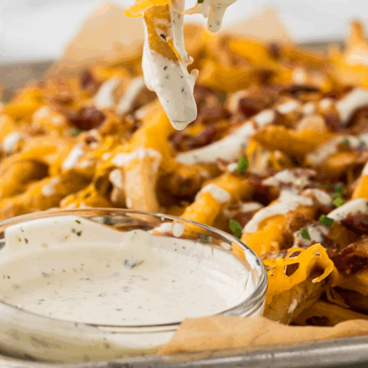 Bowl of creamy Buffalo Wild Wings-style ranch dressing, garnished with herbs, ready to serve.