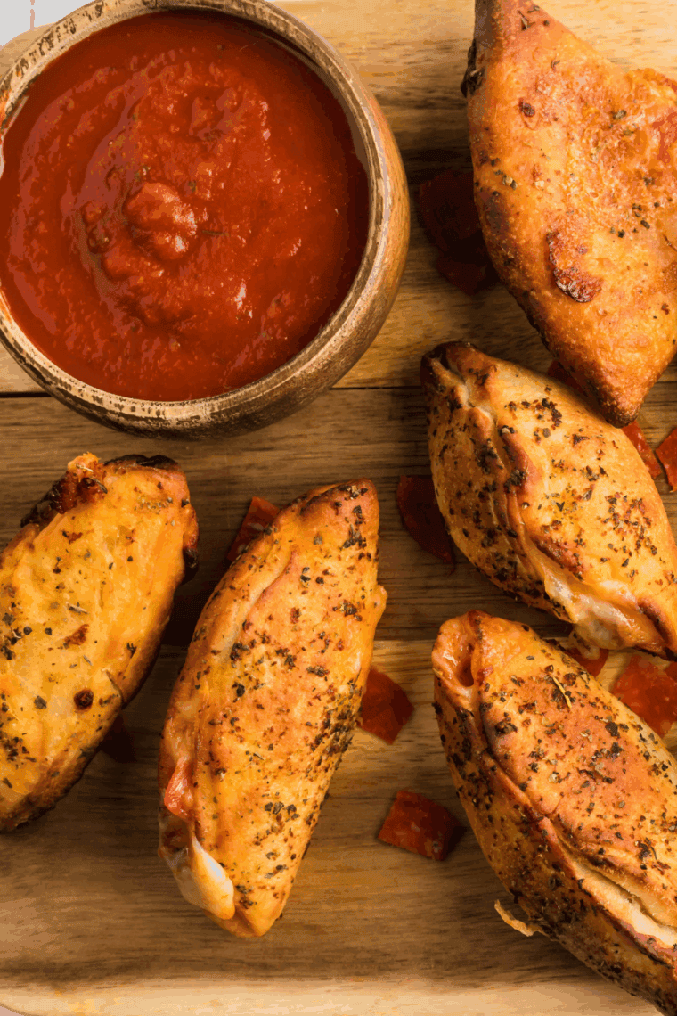 Bowl of Easy Calzone Dipping Sauce, rich red tomato sauce with herbs, ready for dipping.