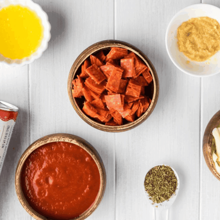 Ingredients needed for Easy Calzone Dipping Sauce on kitchen table.