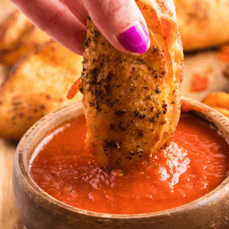 Finished calzone dipping sauce served in a small bowl, ready for dipping calzones or breadsticks.