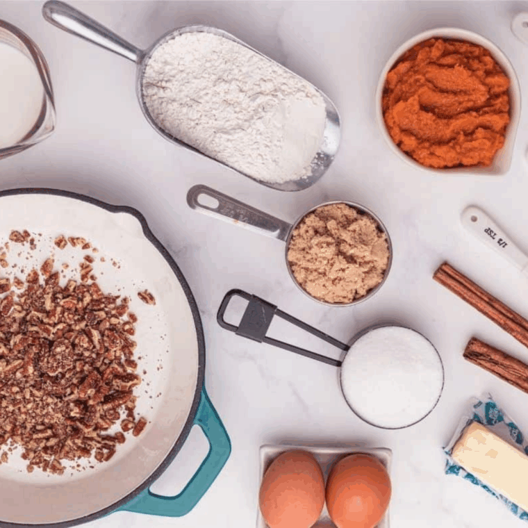 Ingredients needed for Easy Cardamom Pumpkin Bread Recipe on kitchen table.