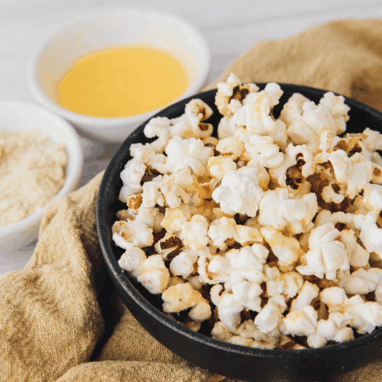 Freshly popped, golden popcorn in a seasoned cast iron skillet